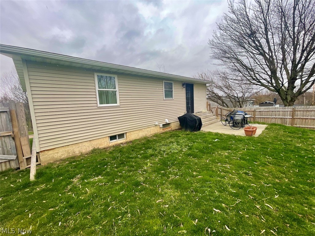 146 Home Street Rittman, OH 44270 - Photo 22 of 25 View of home's exterior featuring a yard