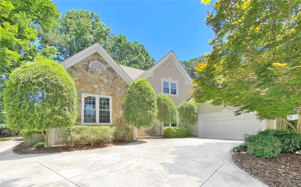 105 Norwick Way Alpharetta, GA 30022 - Photo 1 of 1 a front view of a house with a yard and potted plants