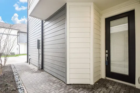 a view of a hallway with wooden floor and entryway