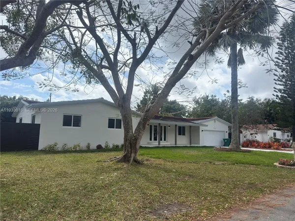 a house that has a tree in front of it