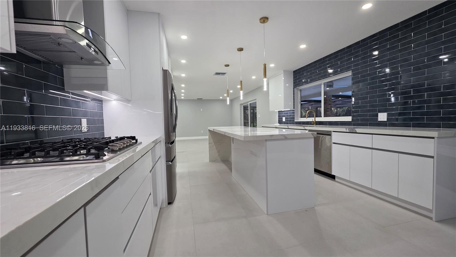10540 Southwest 125th Street Miami, FL 33176 - Photo 11 of 31 a kitchen with stainless steel appliances kitchen island granite countertop a sink and cabinets