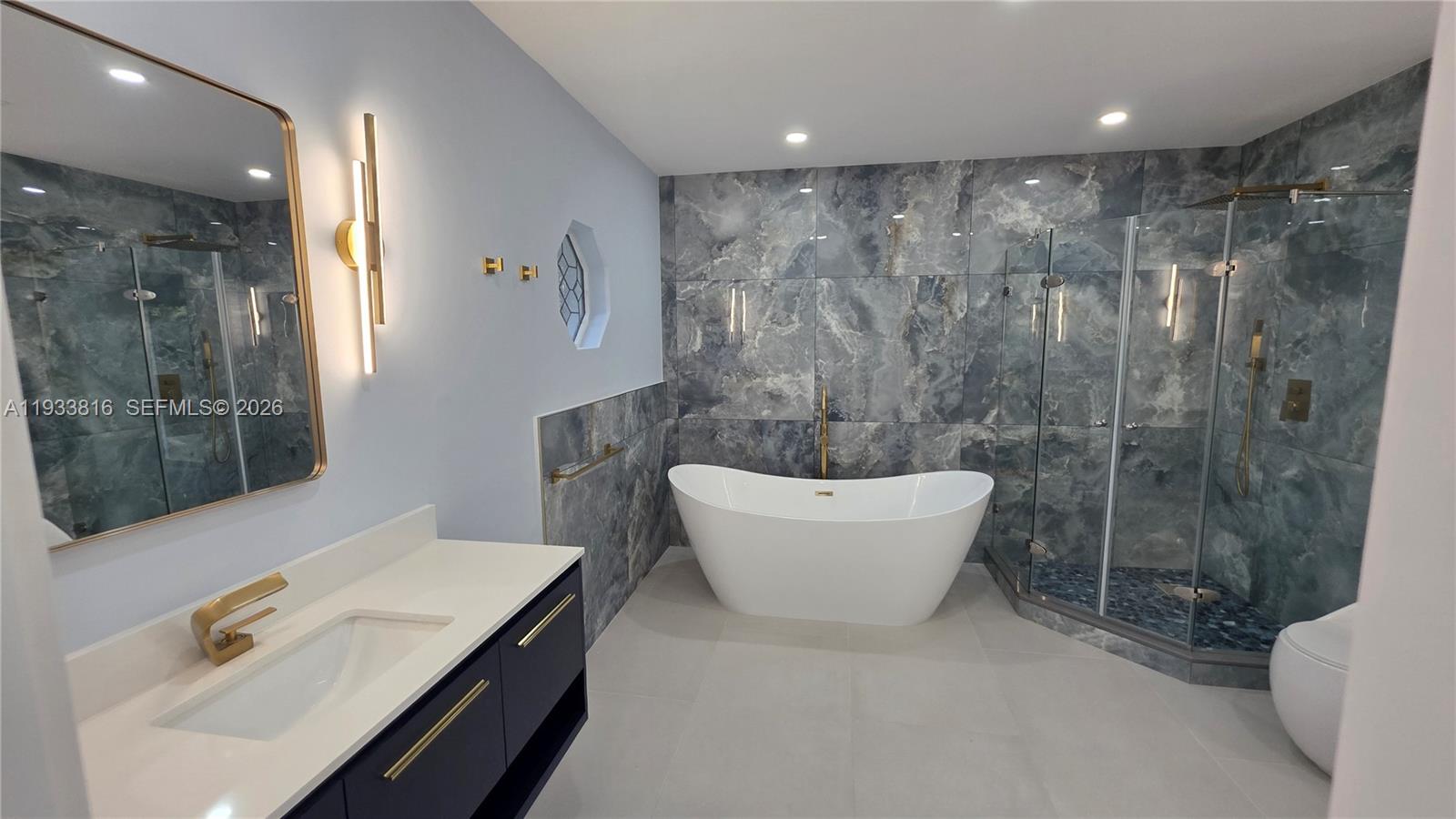 10540 Southwest 125th Street Miami, FL 33176 - Photo 12 of 31 a bathroom with a sink a toilet a mirror and shower