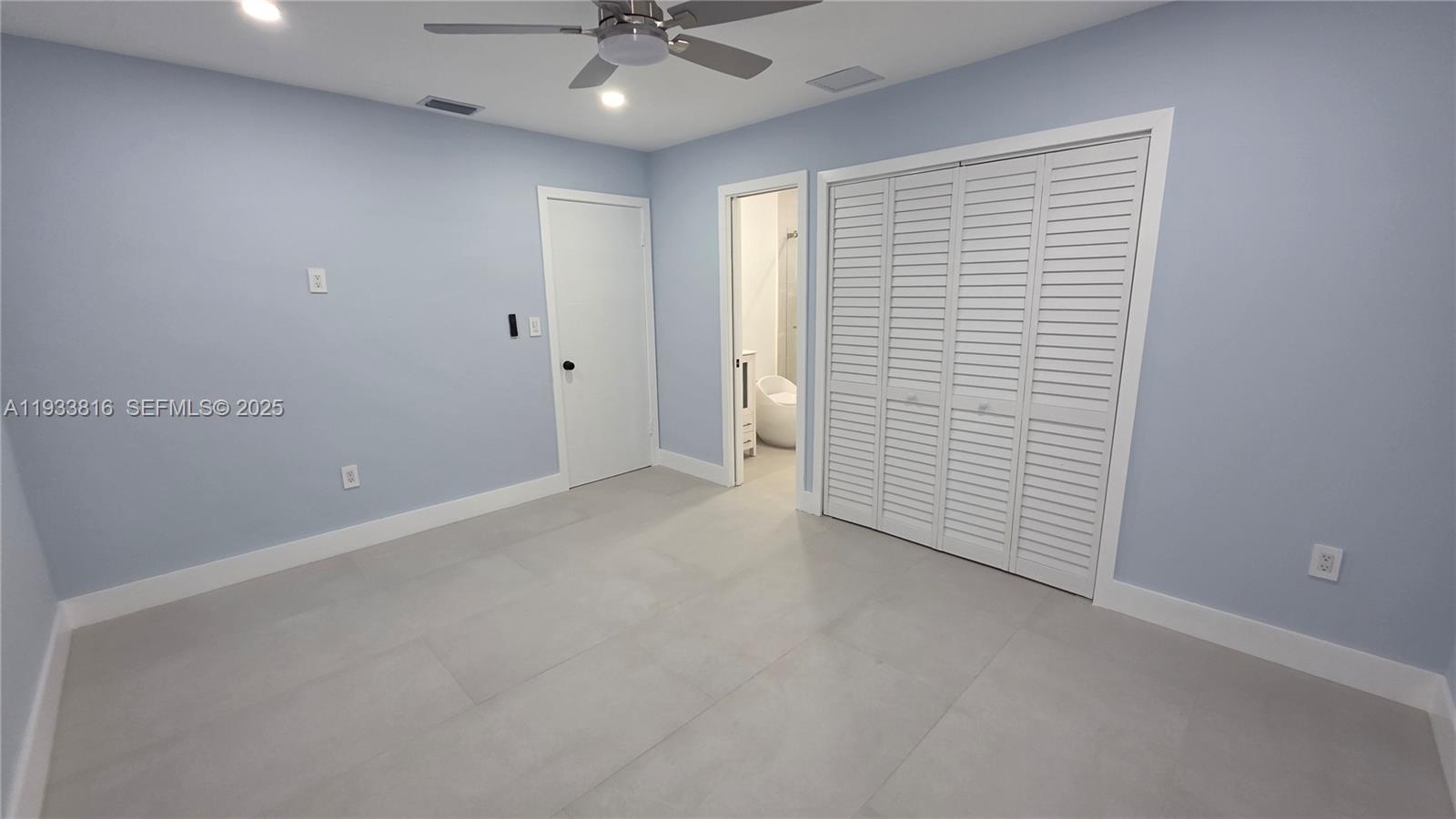 10540 Southwest 125th Street Miami, FL 33176 - Photo 16 of 29 an empty room with a ceiling fan and a window