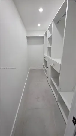 a view of storage and utility room with racks on the wall