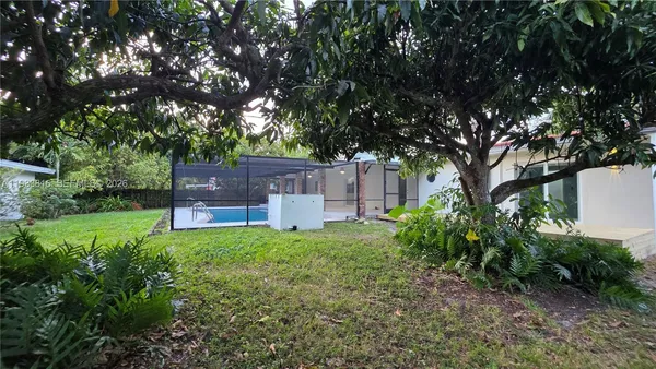 a backyard of a house with table and chairs