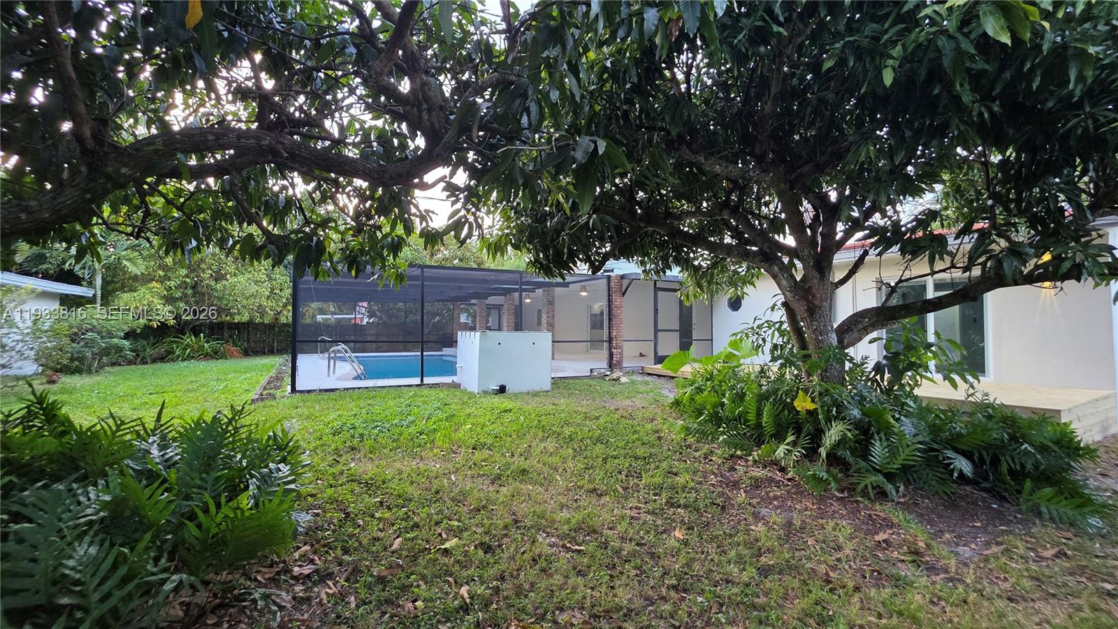 10540 Southwest 125th Street Miami, FL 33176 - Photo 22 of 31 a backyard of a house with table and chairs