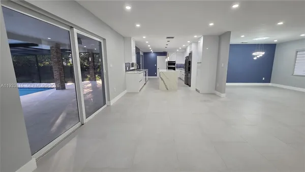 a view of a hallway with kitchen view and living room view
