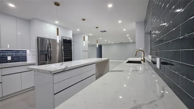 a kitchen with stainless steel appliances a sink stove and cabinets