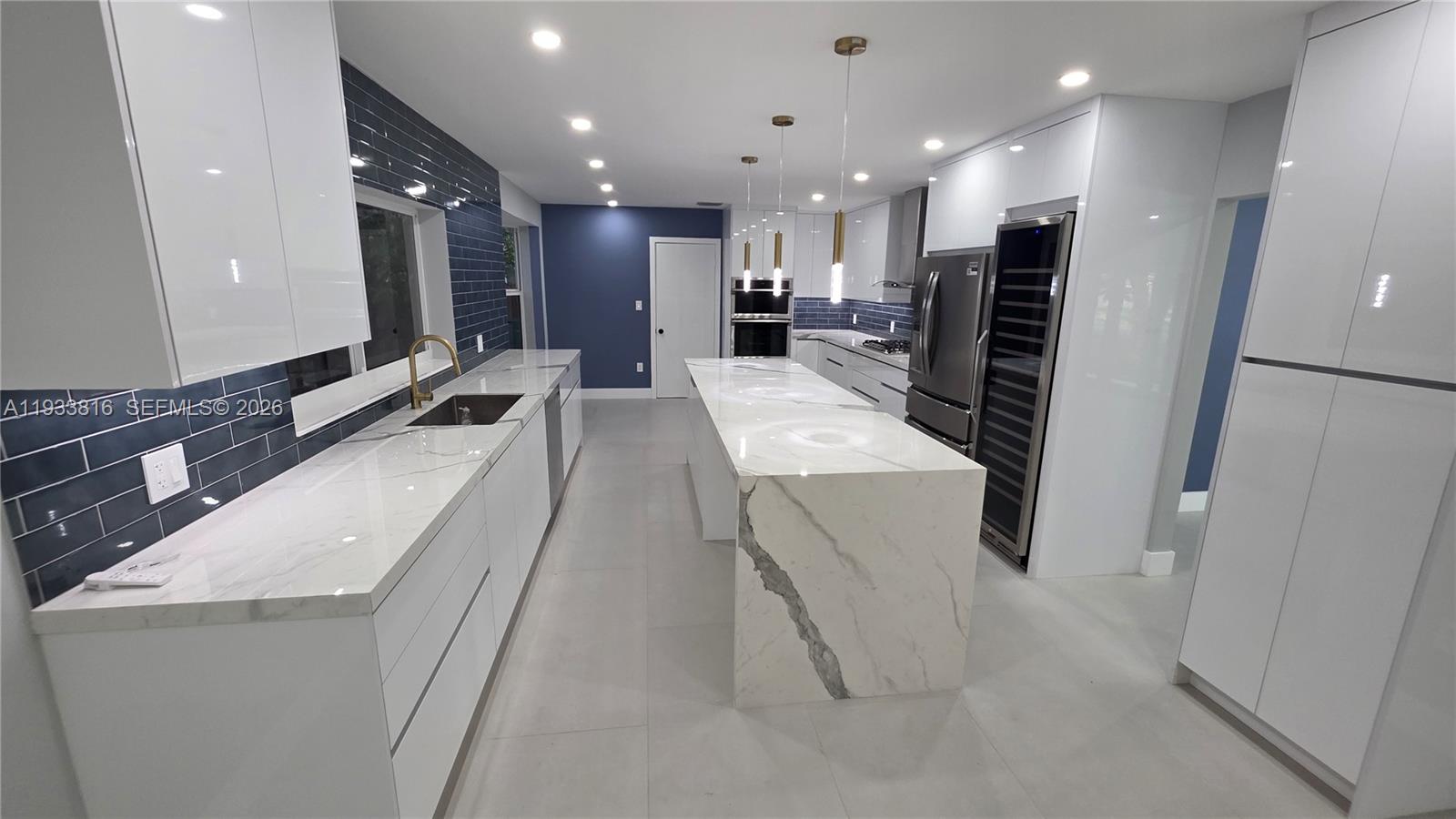 10540 Southwest 125th Street Miami, FL 33176 - Photo 8 of 31 a large white kitchen with a large sink oven and stainless steel appliances