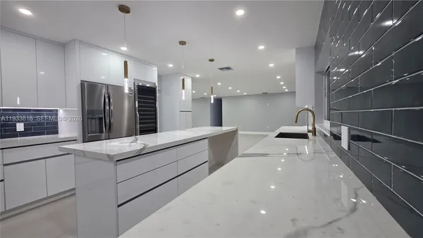 a kitchen with stainless steel appliances a sink stove and cabinets