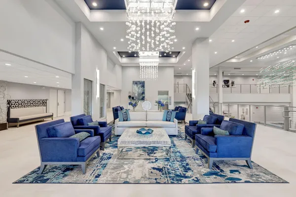 a living room with furniture a chandelier and a chandelier