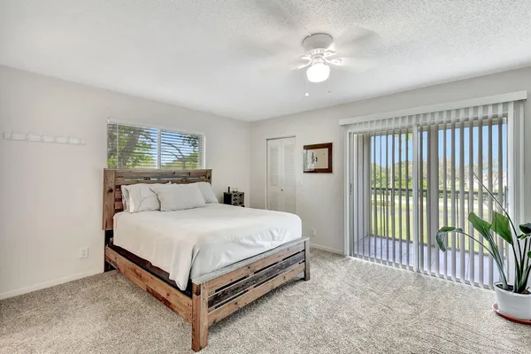 a bed sitting in a bedroom next to a window