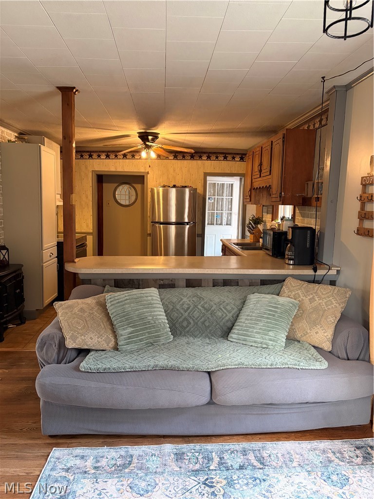 3719 Holmes Road Cambridge, OH 43725 - Photo 9 of 20 Living area featuring ceiling fan and dark wood-style flooring