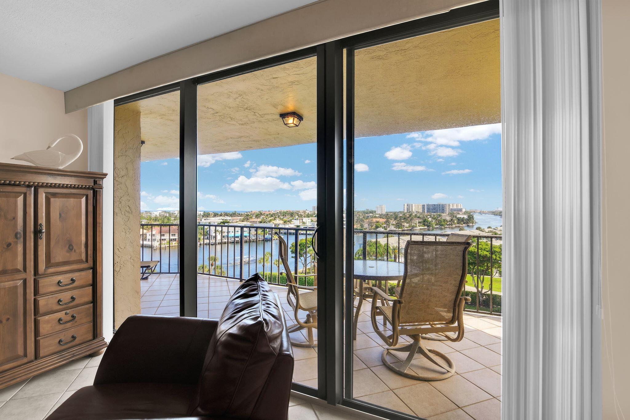 899 Jeffery Street, Unit 809 Boca Raton, FL 33487 - Photo 12 of 96 a view of a balcony with chair and floor to ceiling window