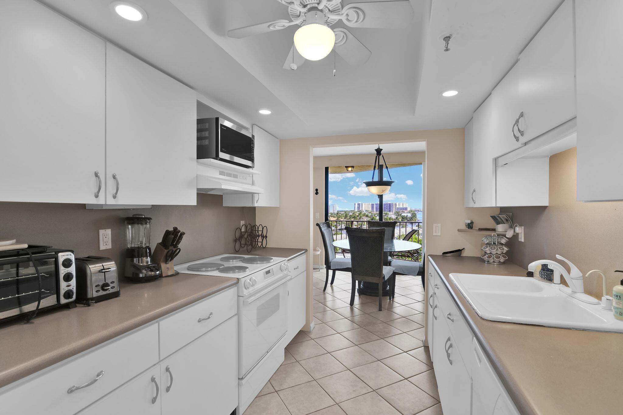 899 Jeffery Street, Unit 809 Boca Raton, FL 33487 - Photo 13 of 96 a kitchen with granite countertop a sink stainless steel appliances and cabinets