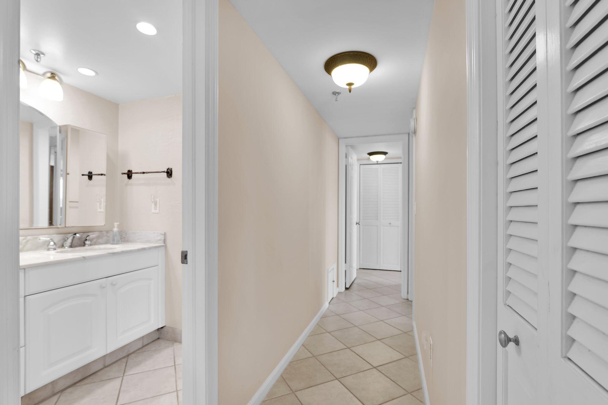 899 Jeffery Street, Unit 809 Boca Raton, FL 33487 - Photo 17 of 96 a bathroom with a sink a mirror and a shower