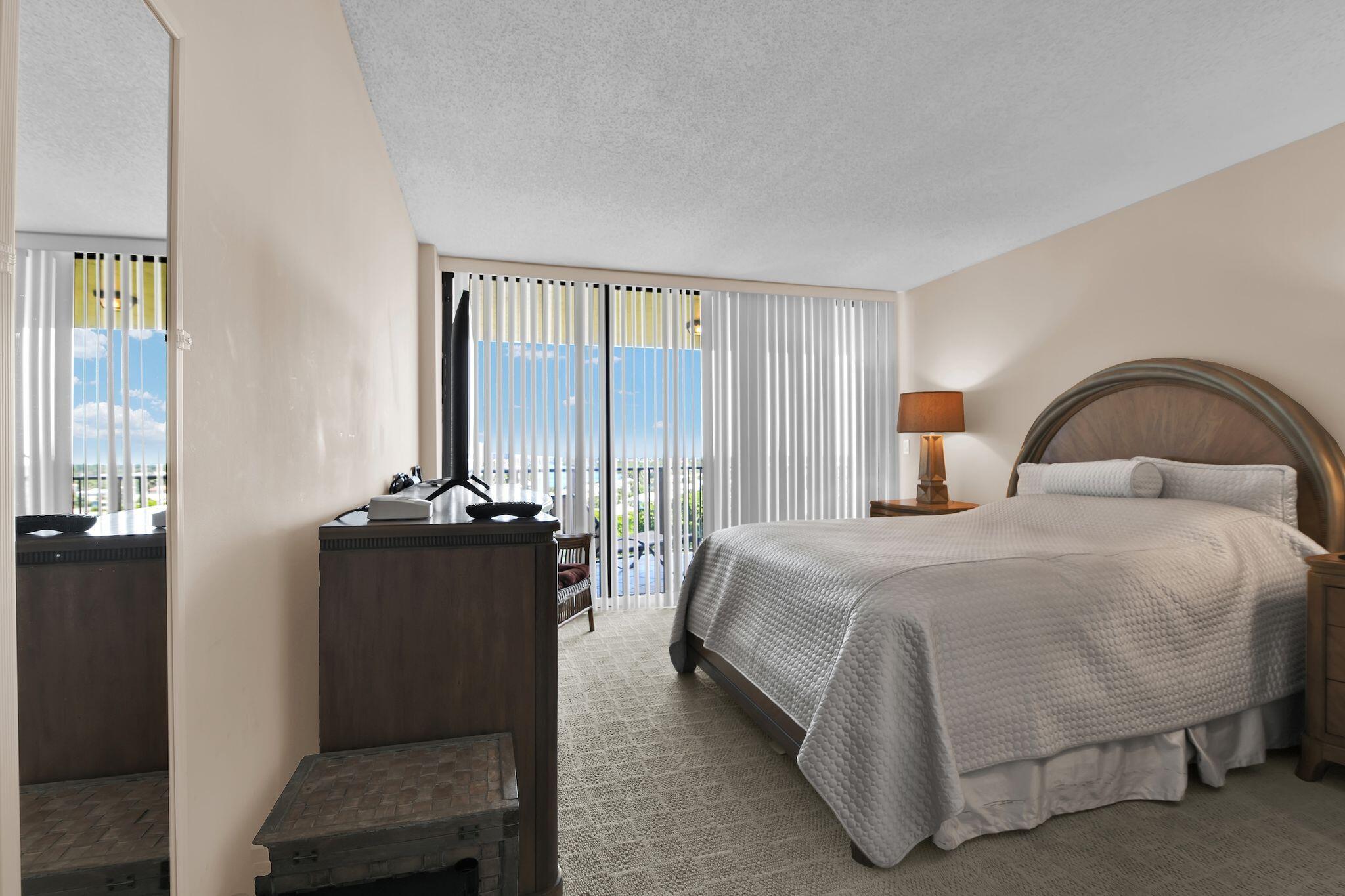 899 Jeffery Street, Unit 809 Boca Raton, FL 33487 - Photo 19 of 96 a bedroom with a bed and a night stand