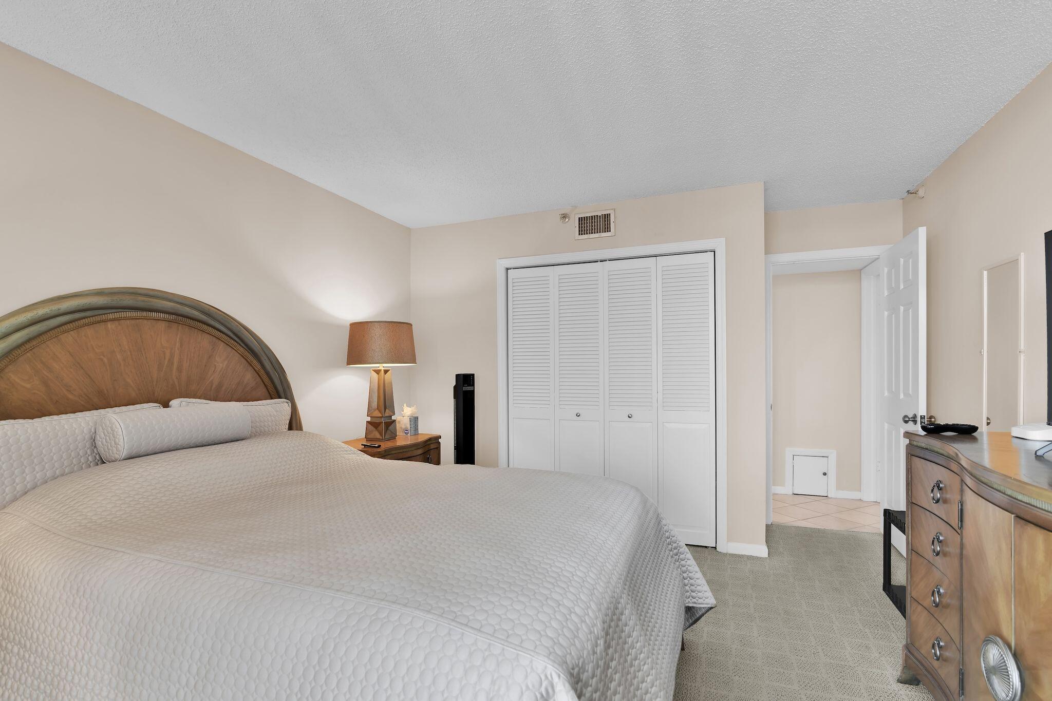 899 Jeffery Street, Unit 809 Boca Raton, FL 33487 - Photo 21 of 96 a bedroom with a bed and a flat tv screen