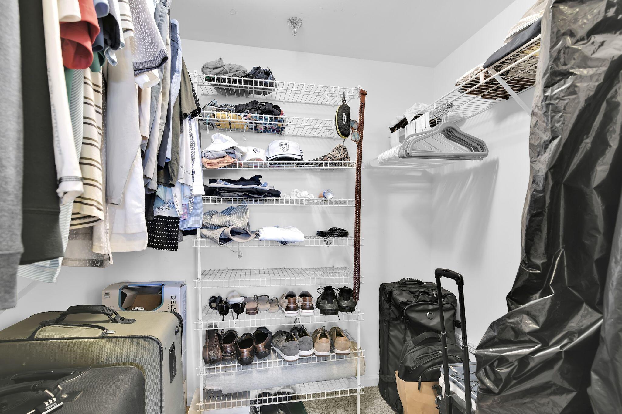 899 Jeffery Street, Unit 809 Boca Raton, FL 33487 - Photo 24 of 96 a view of walk in closet with clothes and shoes