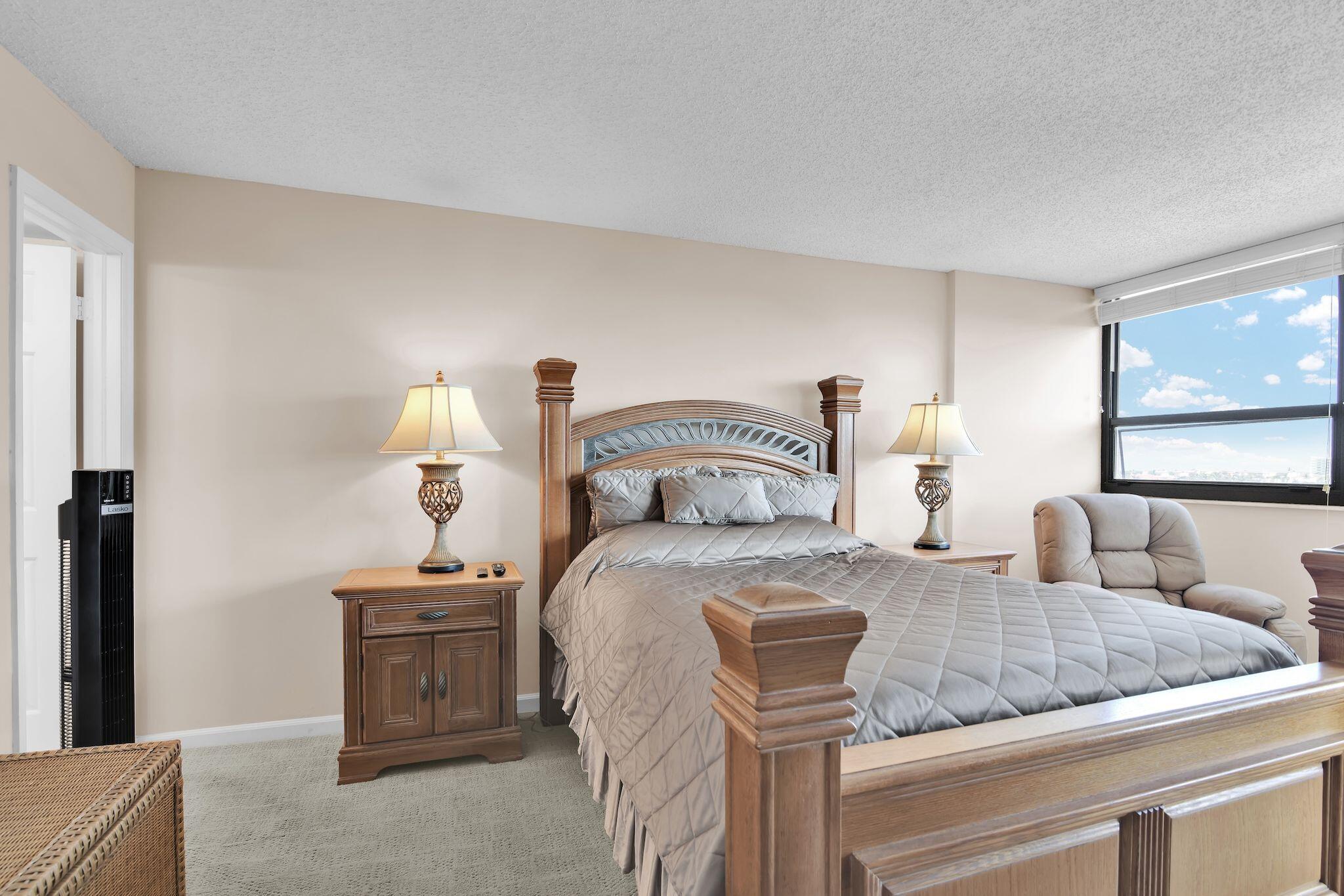 899 Jeffery Street, Unit 809 Boca Raton, FL 33487 - Photo 28 of 96 a bedroom with a bed and chandelier