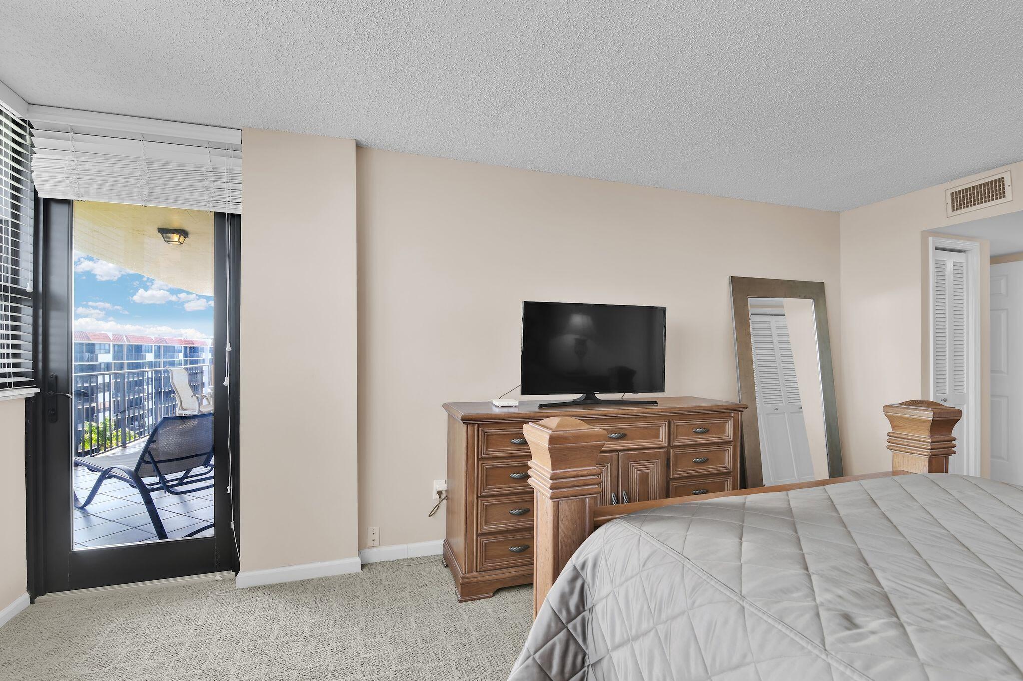 899 Jeffery Street, Unit 809 Boca Raton, FL 33487 - Photo 29 of 96 a bedroom with a bed and a television in it