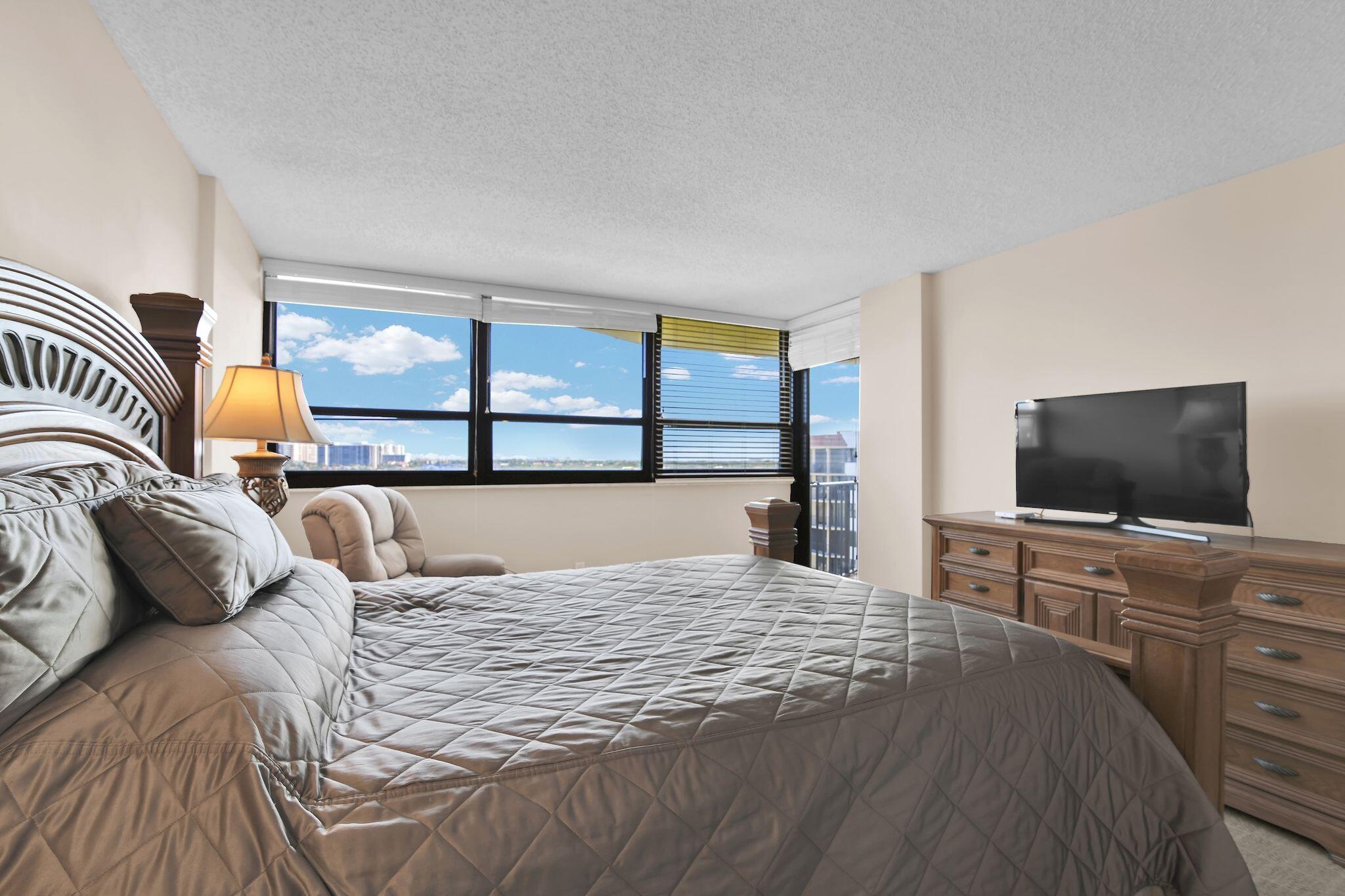 899 Jeffery Street, Unit 809 Boca Raton, FL 33487 - Photo 30 of 96 a bedroom with a bed and a flat screen tv