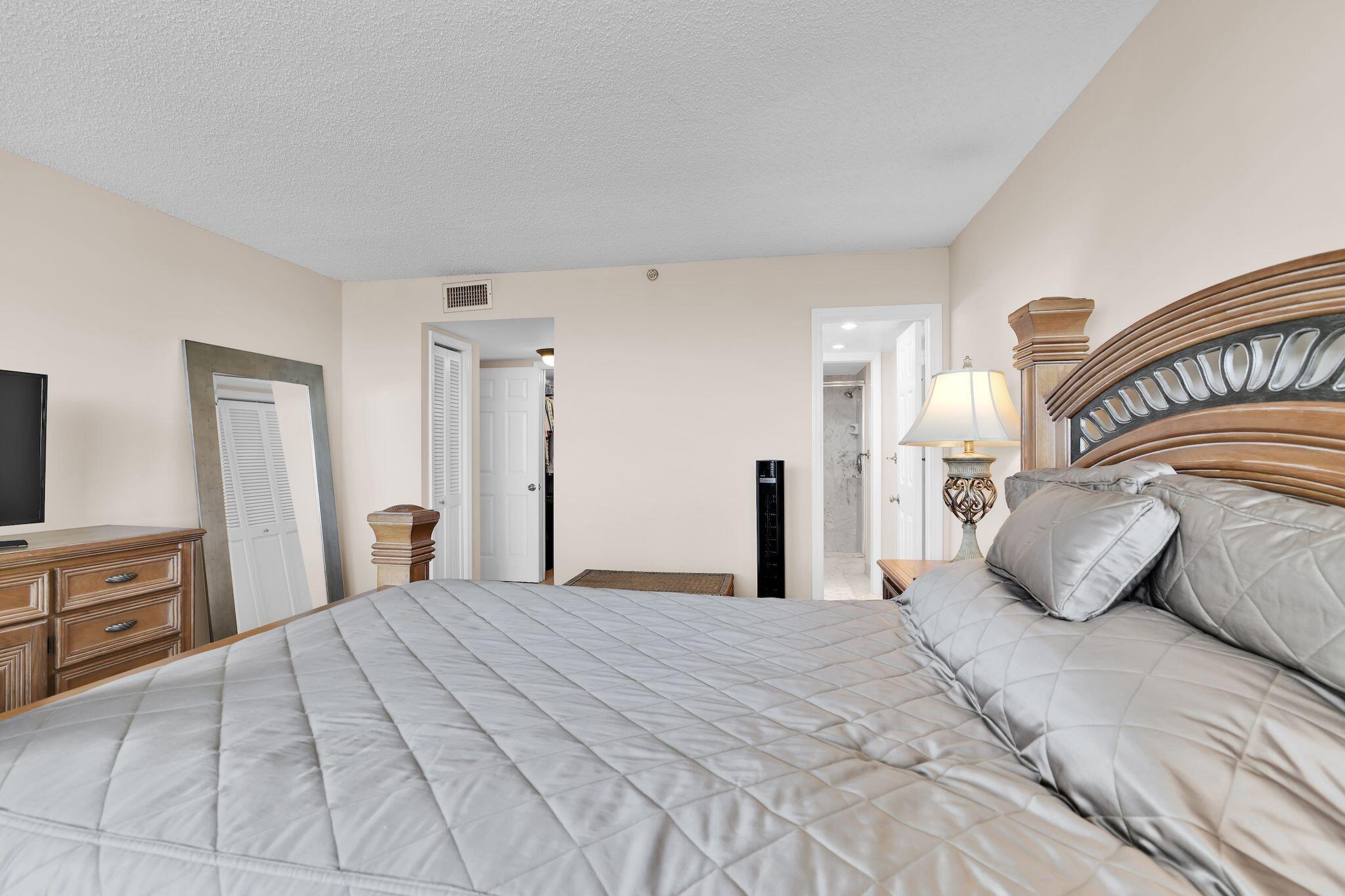 899 Jeffery Street, Unit 809 Boca Raton, FL 33487 - Photo 31 of 96 a bedroom with a large bed and a dresser