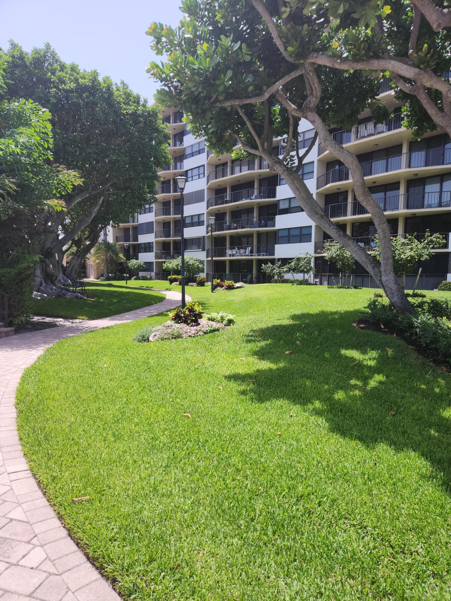 899 Jeffery Street, Unit 809 Boca Raton, FL 33487 - Photo 69 of 96 a view of a big building next to a big yard and large trees