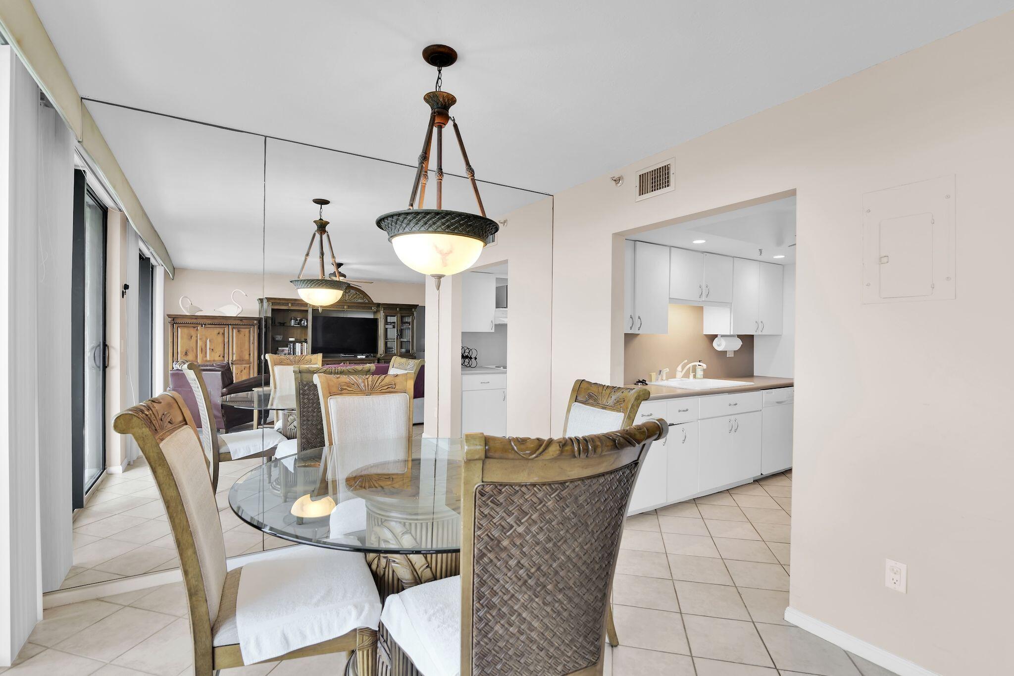 899 Jeffery Street, Unit 809 Boca Raton, FL 33487 - Photo 7 of 96 a view of a dining room with furniture and a chandelier