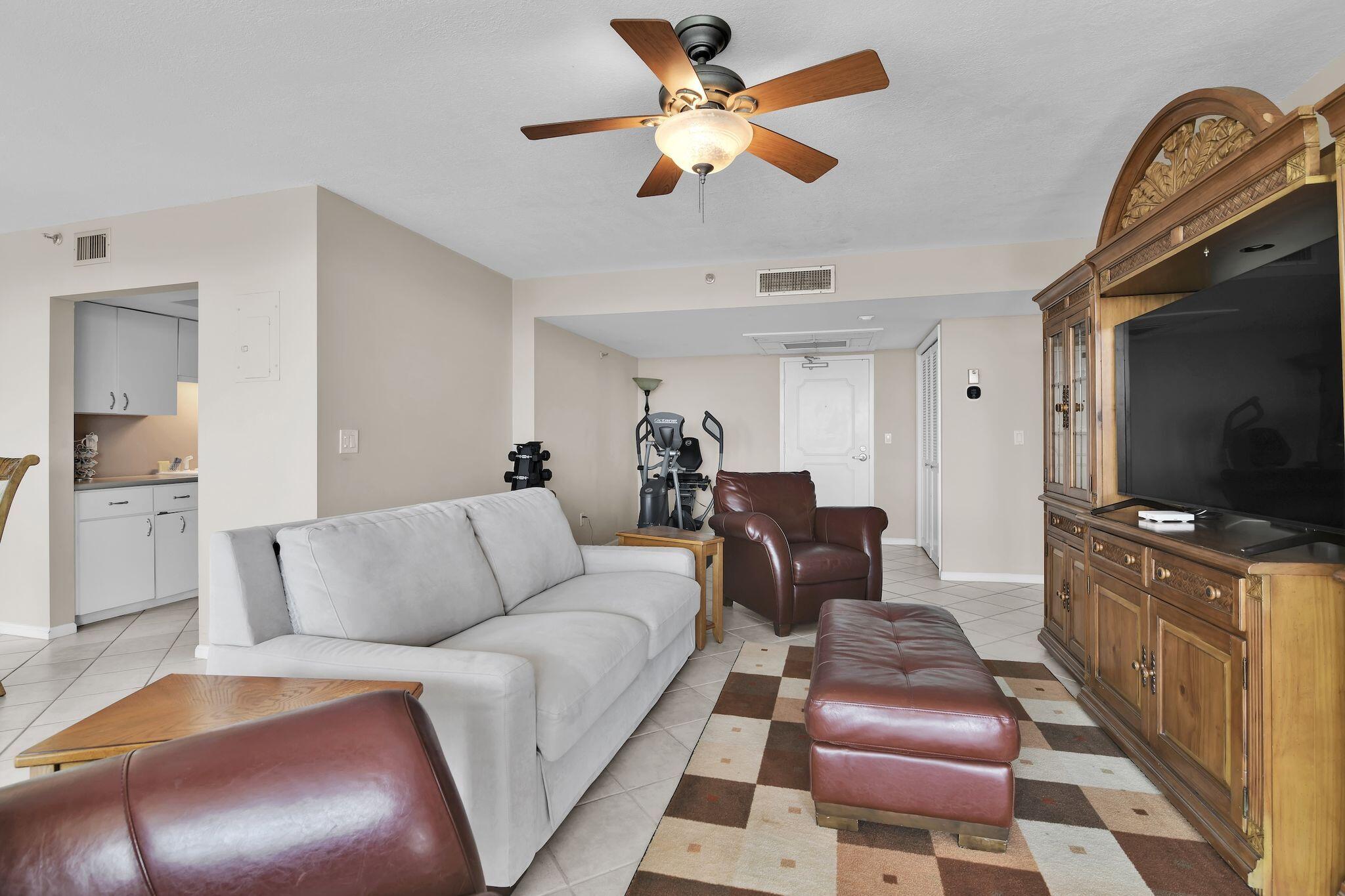 899 Jeffery Street, Unit 809 Boca Raton, FL 33487 - Photo 9 of 96 a living room with furniture and a flat screen tv