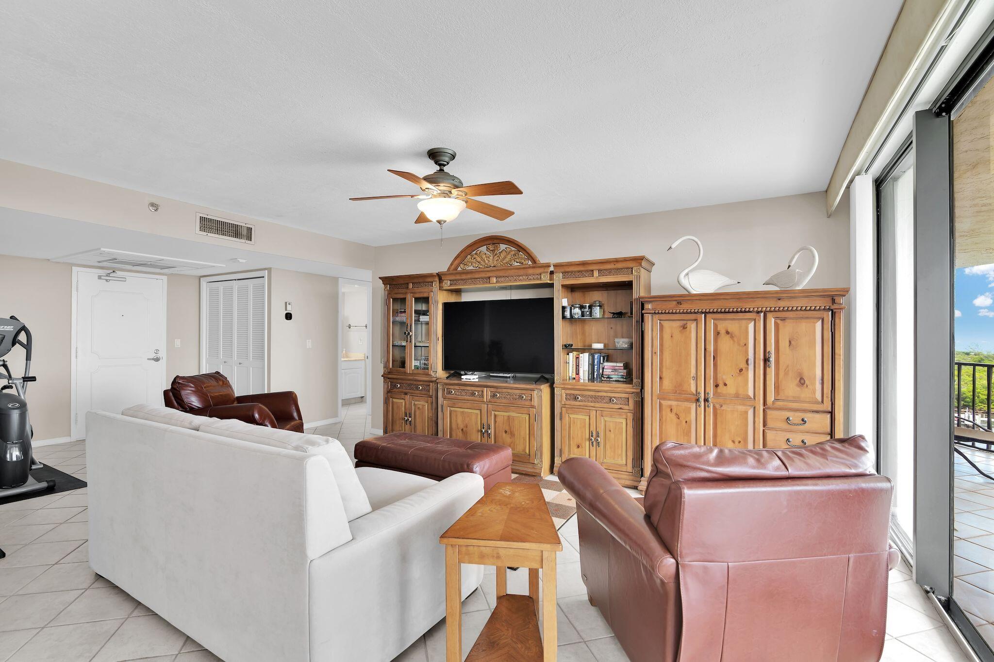 899 Jeffery Street, Unit 809 Boca Raton, FL 33487 - Photo 10 of 96 a living room with furniture a flat screen tv and a large window
