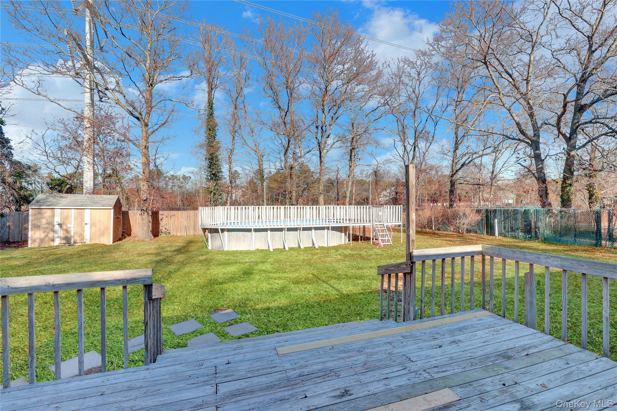 57 Middle Island Road Medford, NY 11763 - Photo 21 of 28 a view of a deck and yard with wooden fence