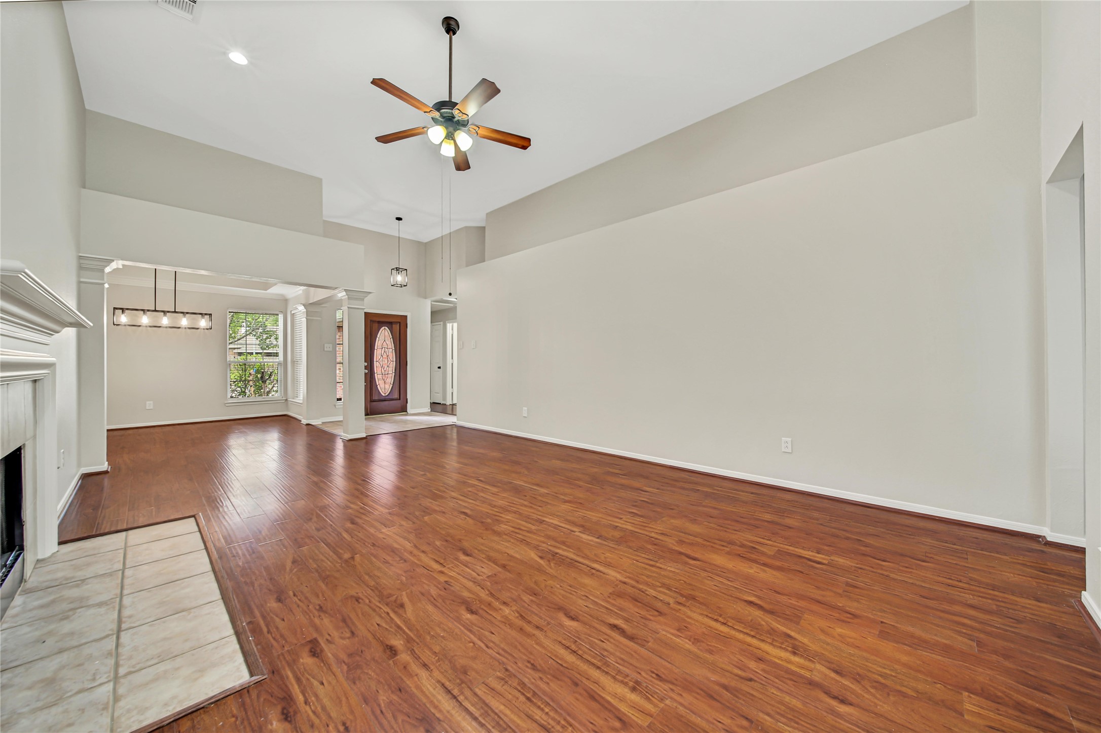 14526 Red Tailed Hawk Lane Houston, TX 77044 - Photo 6 of 40 a view of an empty room with wooden floor and a ceiling fan