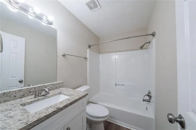 a view of a room with window and a ceiling fan