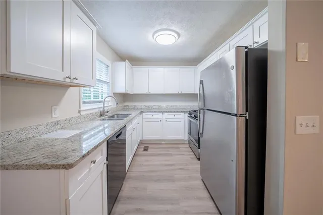 a kitchen with a refrigerator and a sink