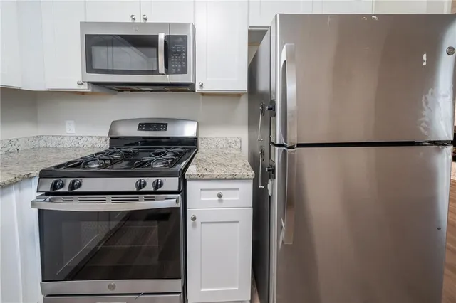 a kitchen with cabinets and stainless steel appliances