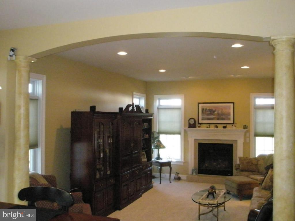 3008 Weaver Road Lititz, PA 17543 - Photo 2 of 12 a living room with furniture a fireplace and a flat screen tv