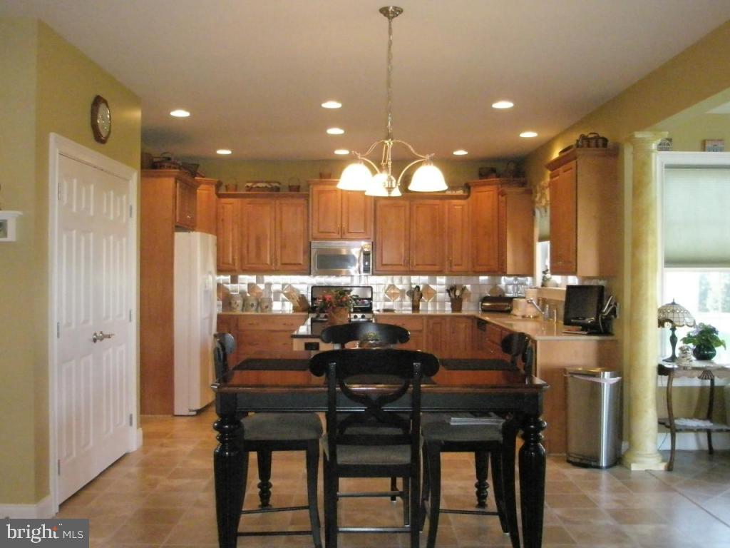 3008 Weaver Road Lititz, PA 17543 - Photo 4 of 12 a kitchen with a table chairs refrigerator and microwave