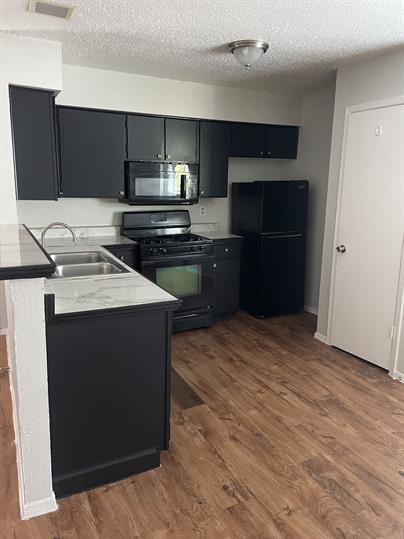 a kitchen with a sink and a stove top oven