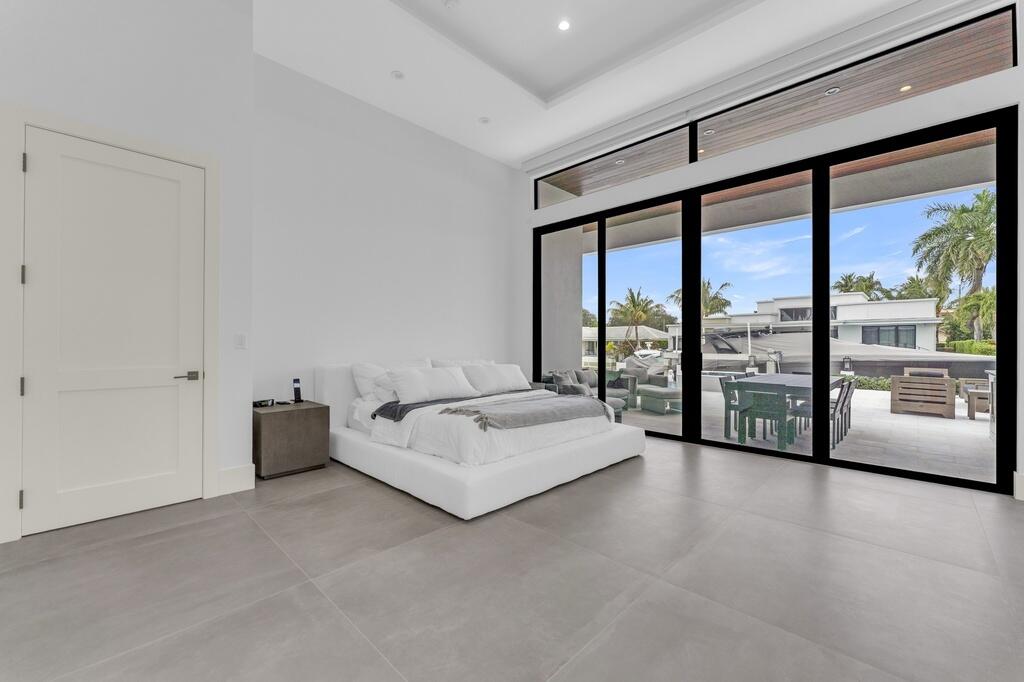 923 Eve Street Delray Beach, FL 33483 - Photo 21 of 69 a spacious bedroom with a large bed and a large window