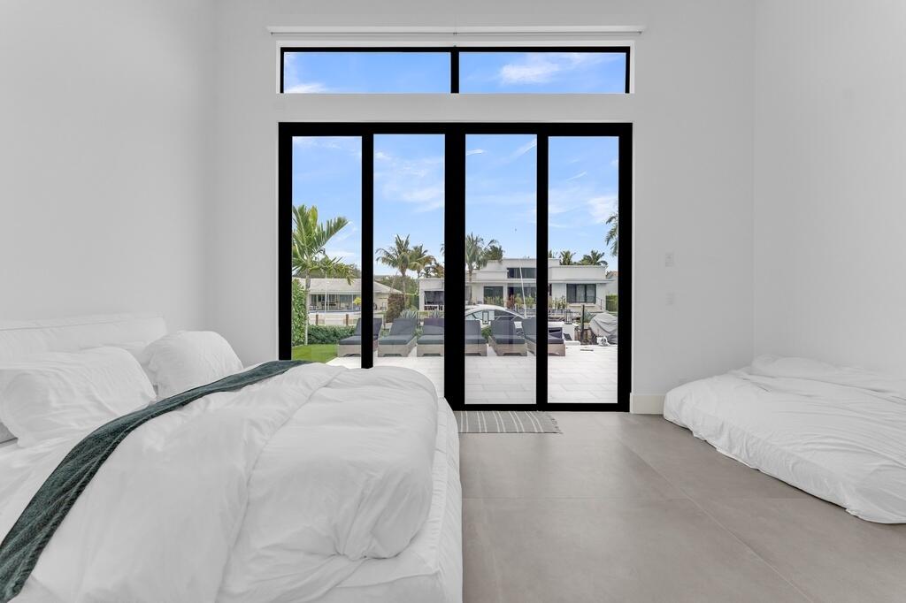 923 Eve Street Delray Beach, FL 33483 - Photo 26 of 69 a bedroom with a large bed and a large window