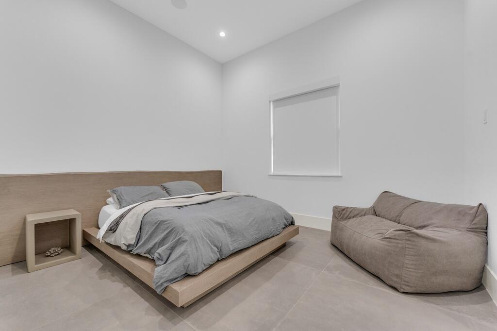 923 Eve Street Delray Beach, FL 33483 - Photo 27 of 69 a bedroom with bed and a couch