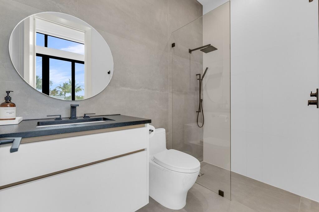 923 Eve Street Delray Beach, FL 33483 - Photo 31 of 69 a bathroom with a sink a toilet and a mirror