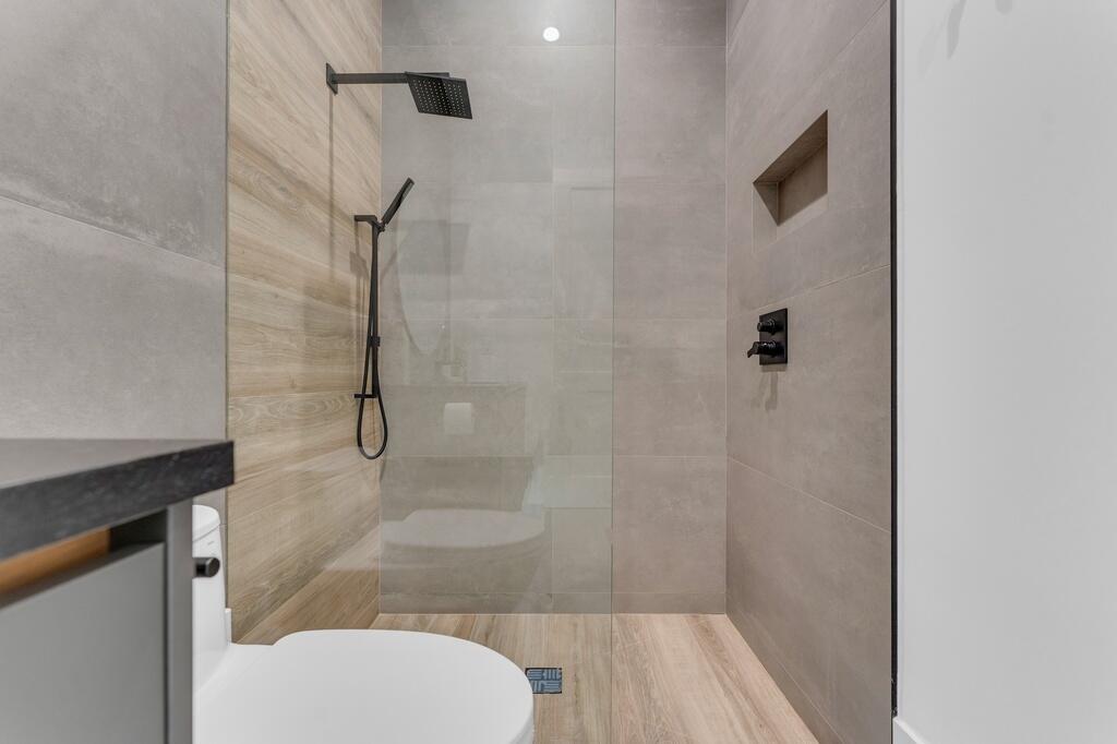 923 Eve Street Delray Beach, FL 33483 - Photo 34 of 69 a bathroom with a shower and toilet