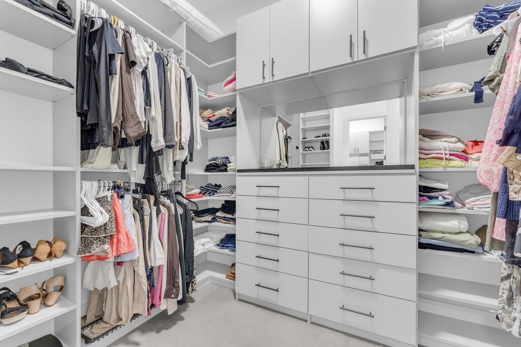 923 Eve Street Delray Beach, FL 33483 - Photo 35 of 69 a view of walk in closet with clothes and shoes