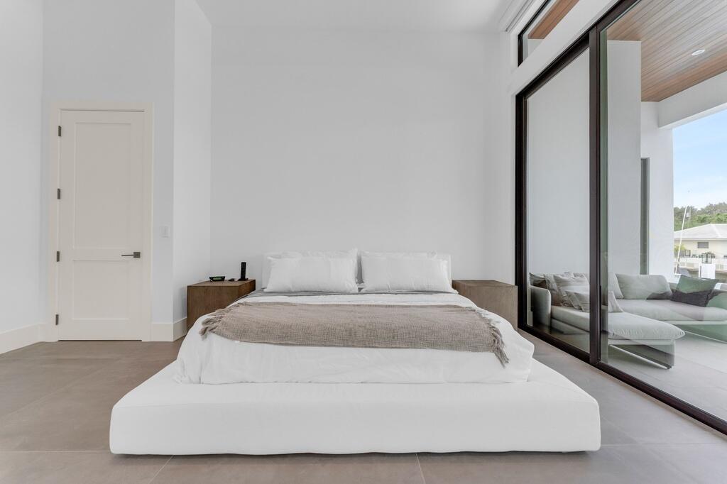 923 Eve Street Delray Beach, FL 33483 - Photo 39 of 69 a spacious bedroom with a bed and window