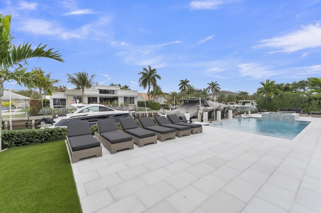 923 Eve Street Delray Beach, FL 33483 - Photo 42 of 69 a view of a swimming pool and lounge chairs in the patio