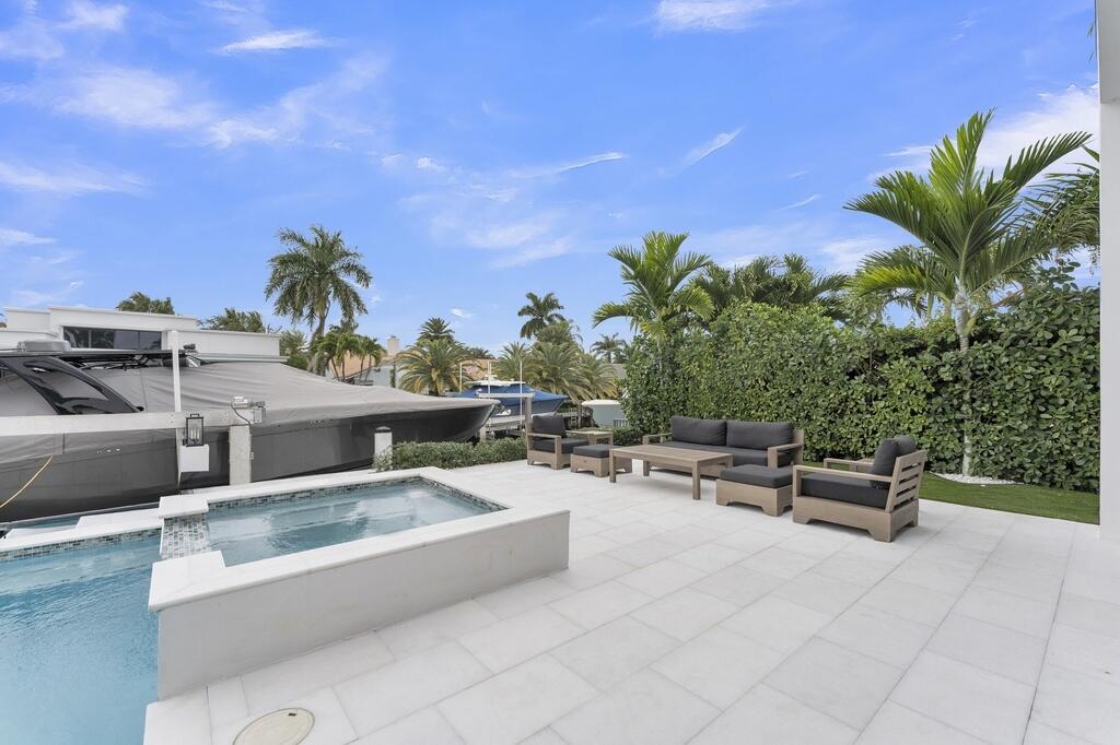 923 Eve Street Delray Beach, FL 33483 - Photo 43 of 69 a view of a terrace with furniture and a fire pit