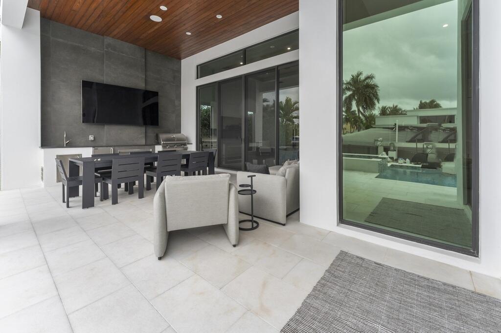 923 Eve Street Delray Beach, FL 33483 - Photo 46 of 69 a lobby with furniture and a flat screen tv