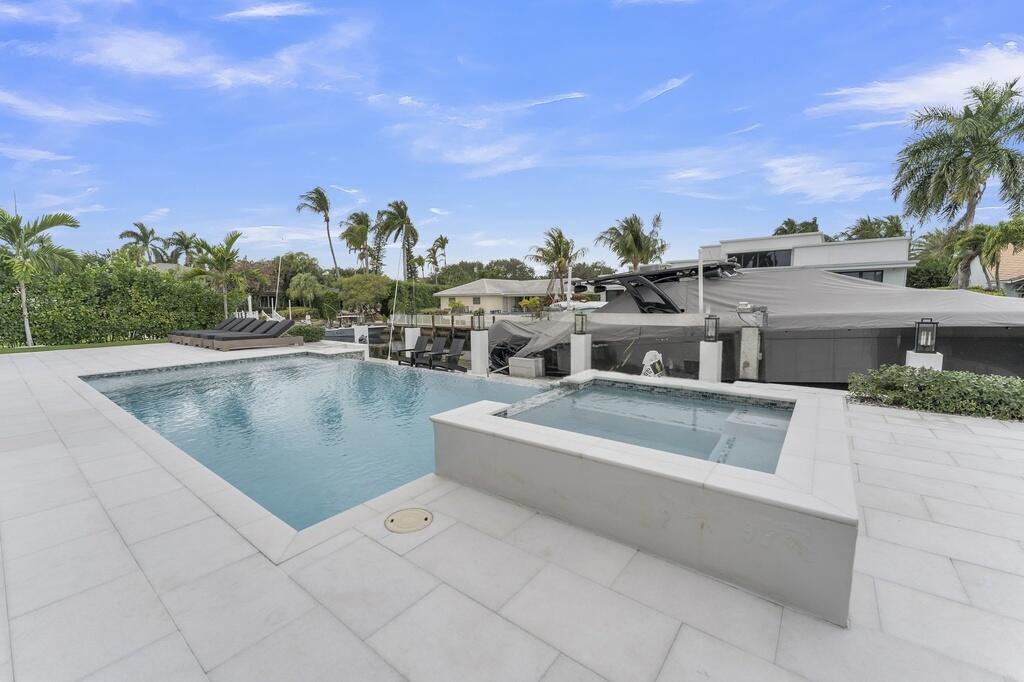 923 Eve Street Delray Beach, FL 33483 - Photo 50 of 69 a view of a swimming pool and an outdoor seating